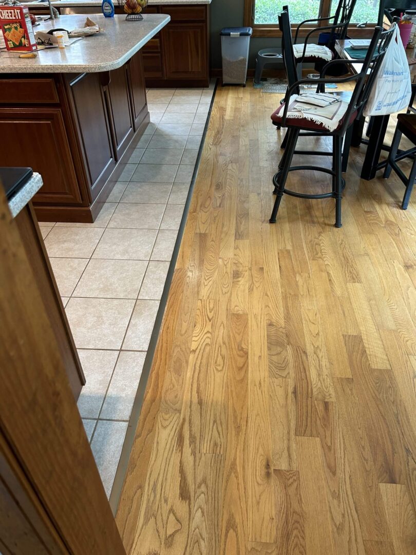 Kitchen with wood and tile flooring transition.
